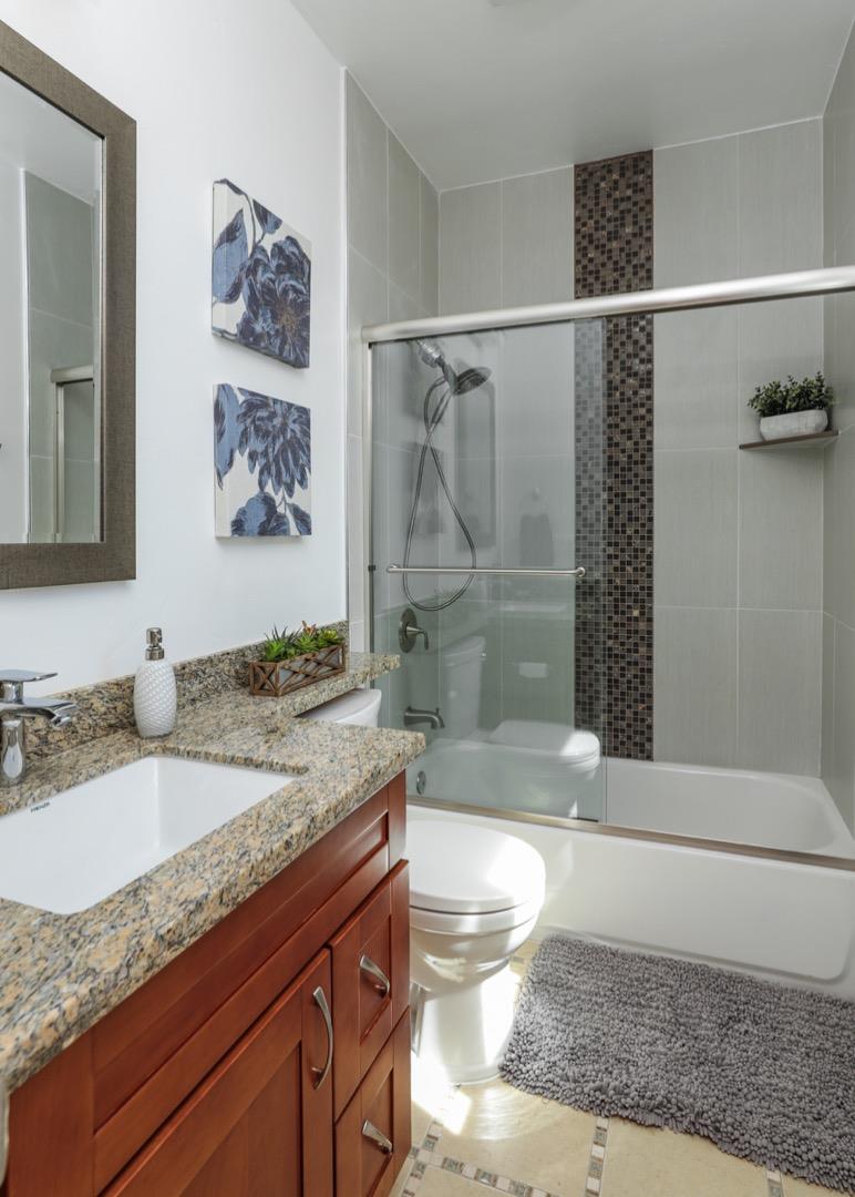 932 Marion Way Sunnyvale, CA 94087 - Photo 9 of 37 a bathroom with a granite countertop sink a toilet and shower