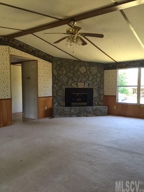3337 Deal Mill Road Hudson, NC 28638 - Photo 12 of 14 an empty room with windows and fireplace