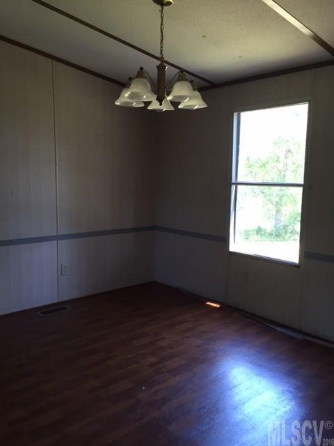 3337 Deal Mill Road Hudson, NC 28638 - Photo 13 of 14 a view of an empty room with wooden floor and a window