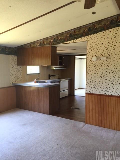 3337 Deal Mill Road Hudson, NC 28638 - Photo 6 of 14 a kitchen with stainless steel appliances kitchen island granite countertop a sink