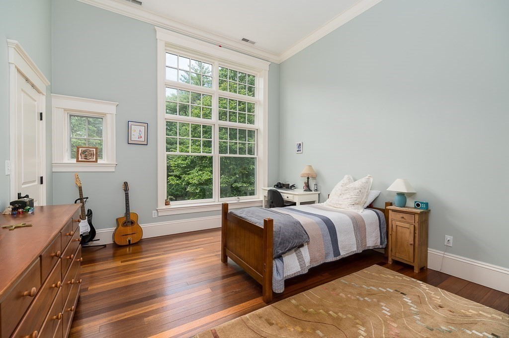 108 Grapevine Road Wenham, MA 01984 - Photo 26 of 37 a spacious bedroom with a bed and wooden floor