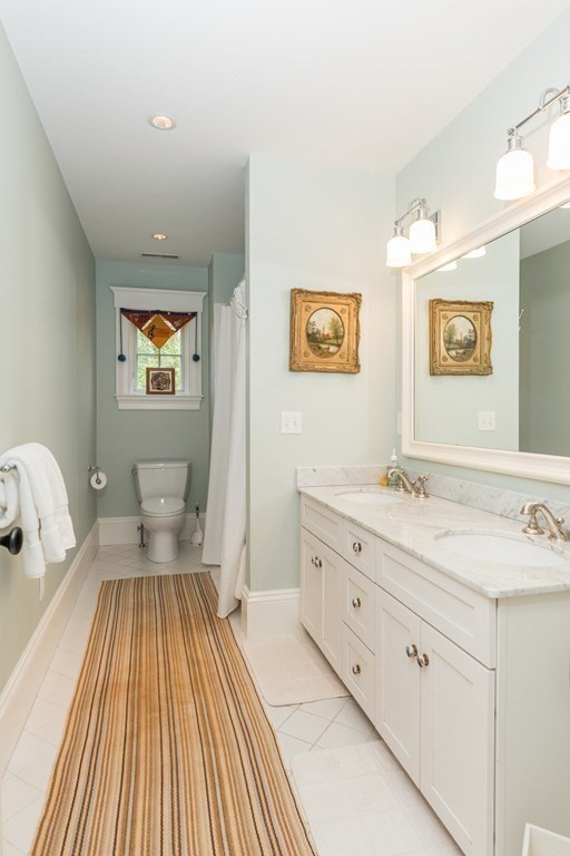 108 Grapevine Road Wenham, MA 01984 - Photo 27 of 37 a spacious bathroom with a granite countertop sink and a mirror