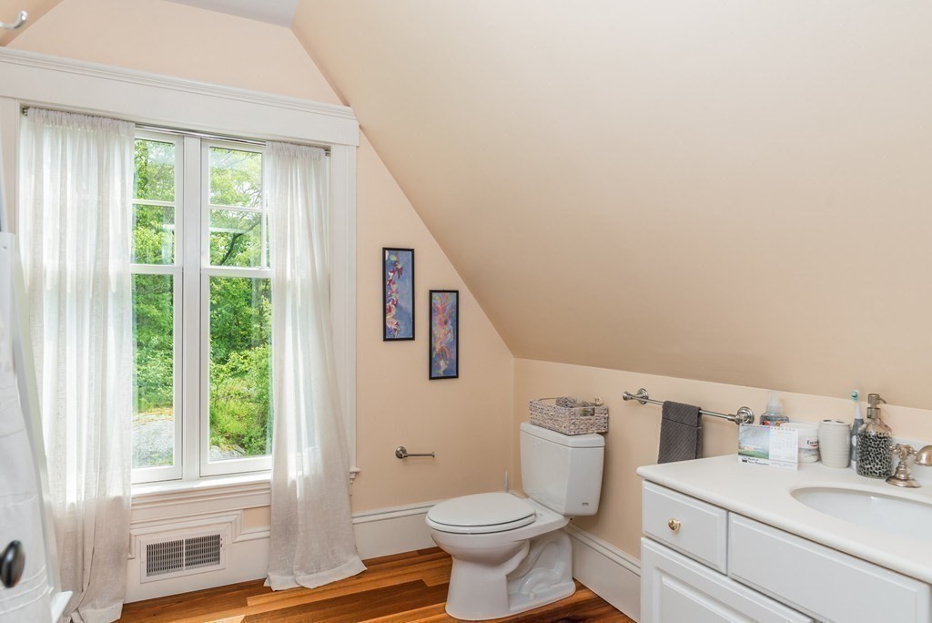 108 Grapevine Road Wenham, MA 01984 - Photo 33 of 37 a bathroom with a sink toilet vanity and window