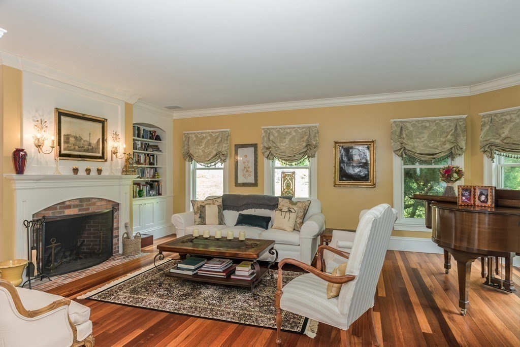 108 Grapevine Road Wenham, MA 01984 - Photo 8 of 37 a living room with furniture a fireplace and a table