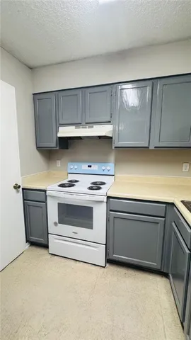 a view of a refrigerator and window in a room