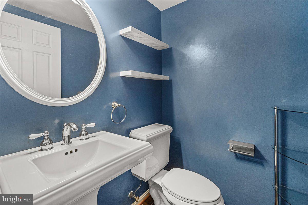 2801 Grandview Drive Middletown, MD 21769 - Photo 6 of 59 a white toilet sitting next to a bathroom sink