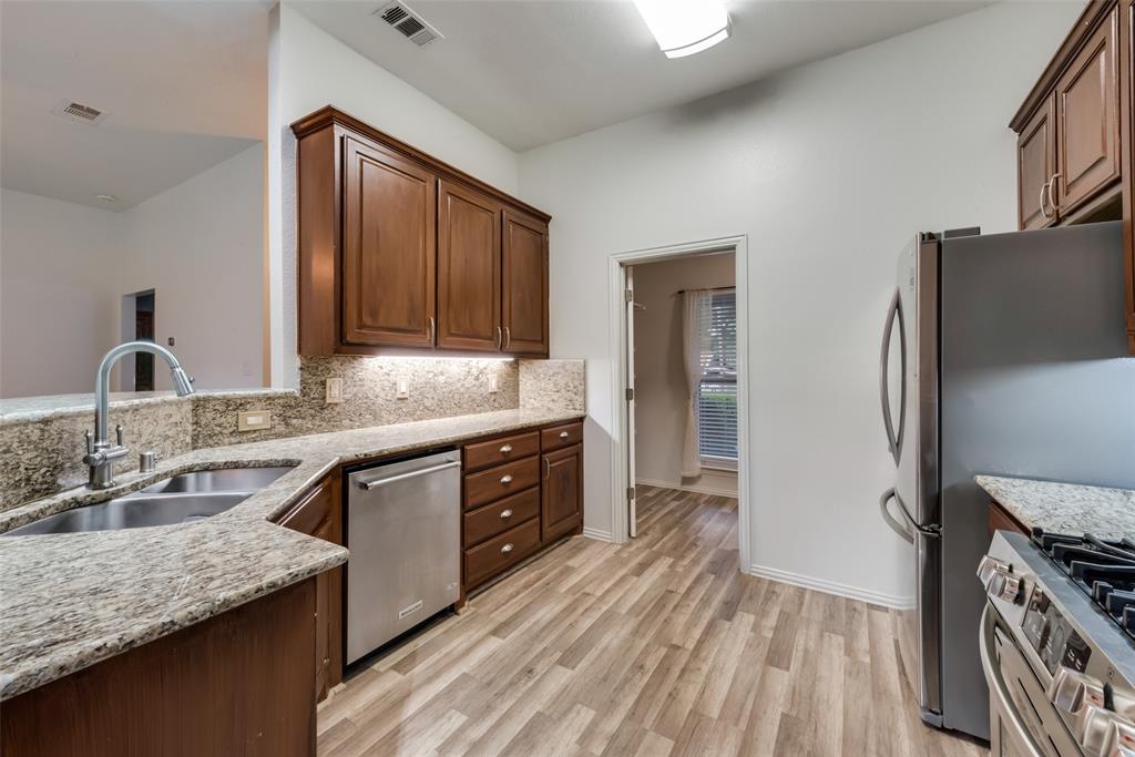 106 South 3rd Avenue Mansfield, TX 76063 - Photo 11 of 30 a kitchen with granite countertop a sink stove and refrigerator