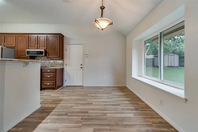 a view of a kitchen with a sink a refrigerator and window