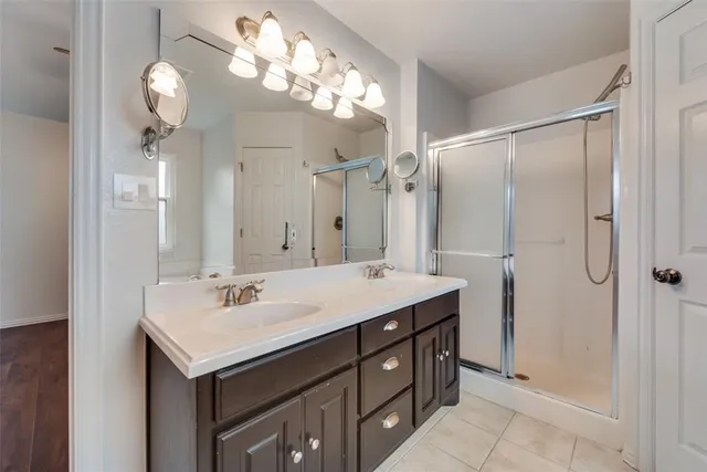 a bathroom with a sink vanity and a mirror