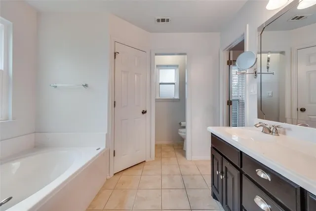 a bathroom with a sink a mirror and a bathtub