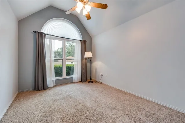 an empty room with windows and mirror