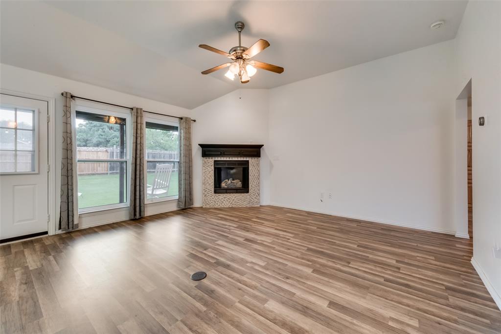 106 South 3rd Avenue Mansfield, TX 76063 - Photo 3 of 30 a view of an empty room with a window and wooden floor