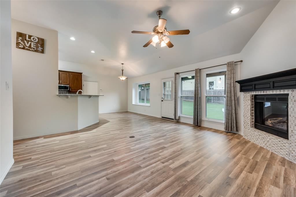 106 South 3rd Avenue Mansfield, TX 76063 - Photo 6 of 30 a view of an empty room with a fireplace and a window