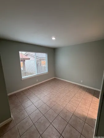 a view of an empty room and a window