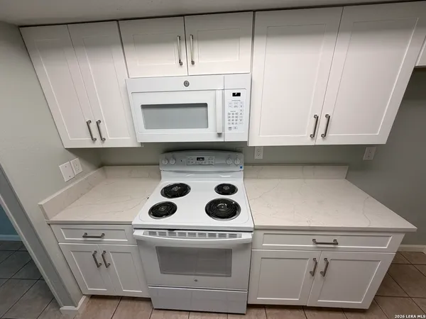 a stove top oven sitting inside of a kitchen