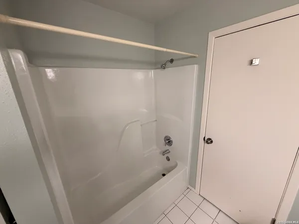 a bathroom with a shower and a tub