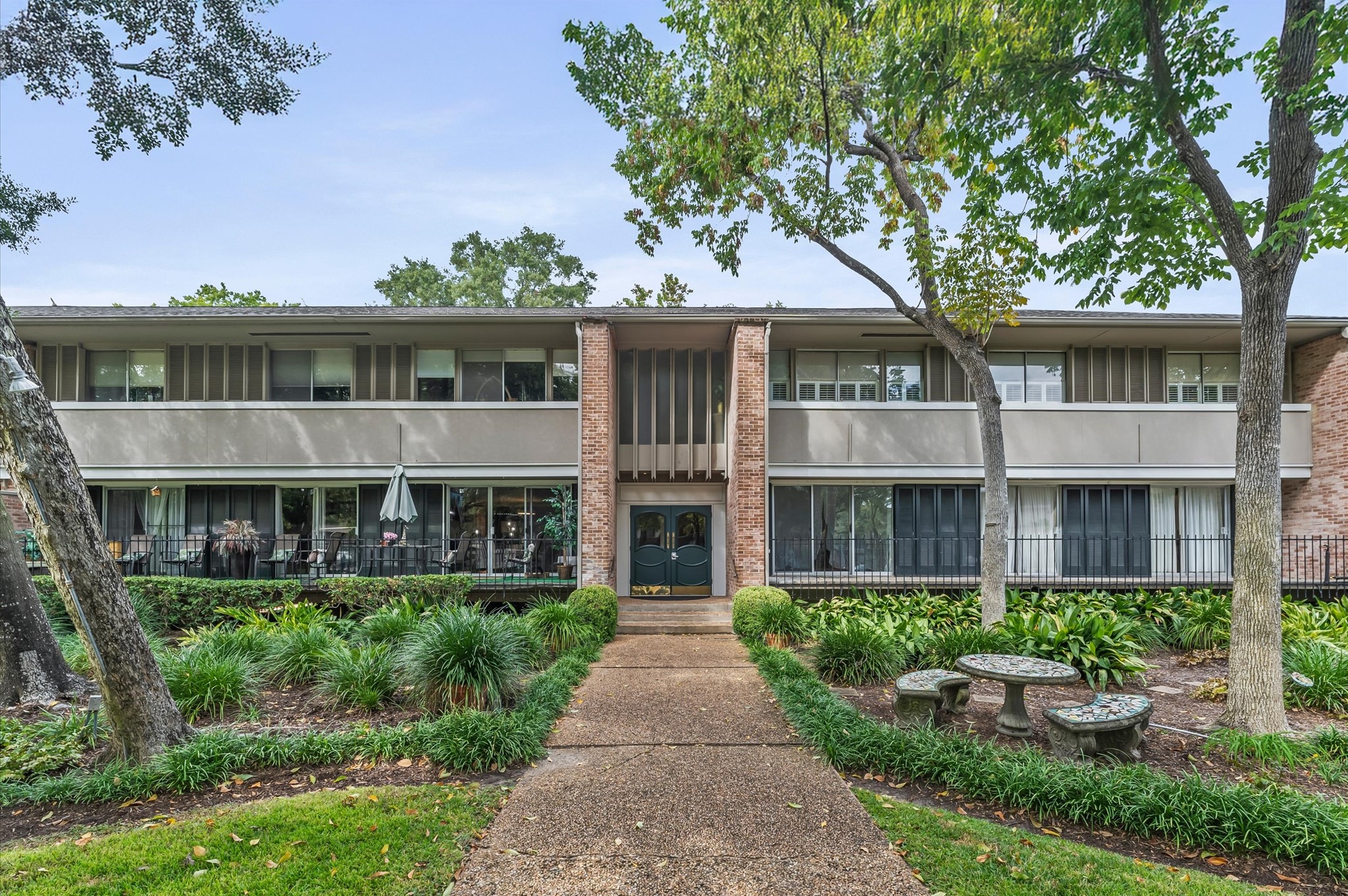 a front view of a house with a garden