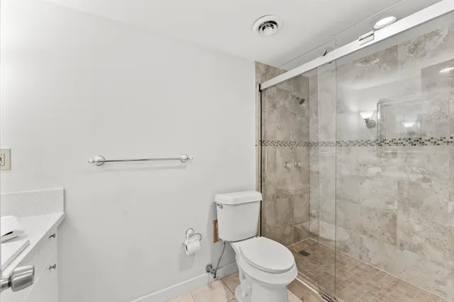 a bathroom with a toilet and a shower