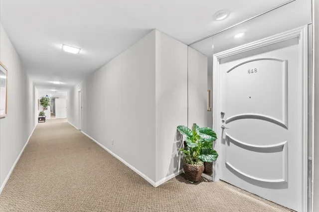 a bathroom with a granite countertop sink a toilet and a mirror