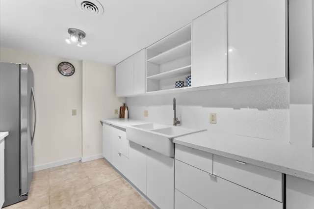 a kitchen with a sink and white cabinets