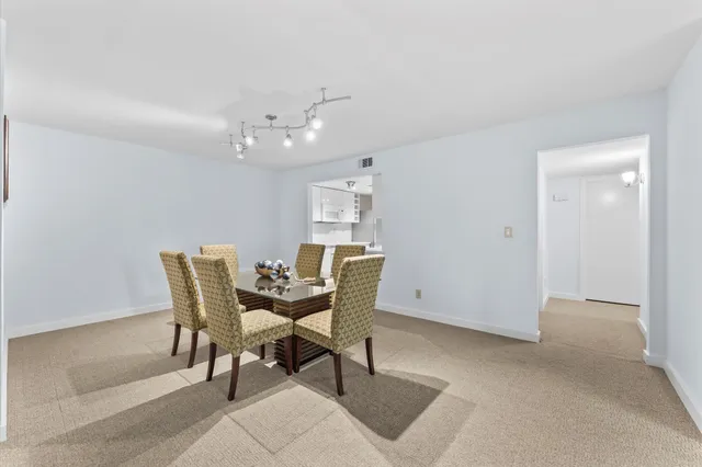 a view of a dining room with furniture and chandelier