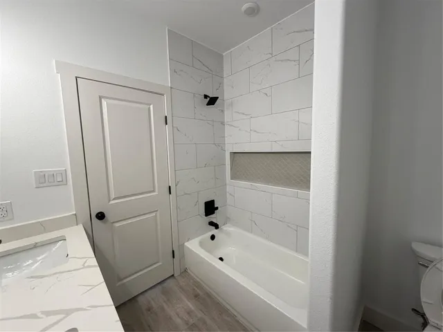 a bathroom with a bathtub a toilet and a shower