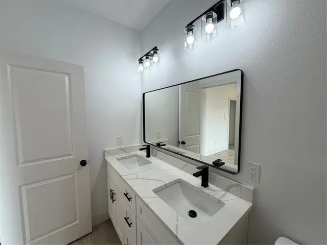 a bathroom with a sink and mirror