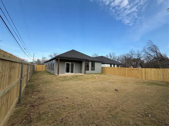 a yellow house with yard in front of it