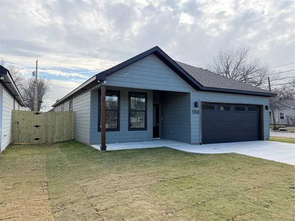 a view of a house with backyard and garage