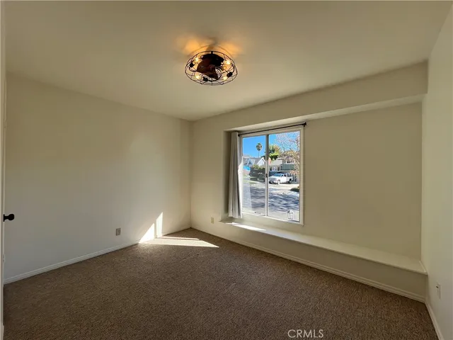 a view of room with window and ceiling fan