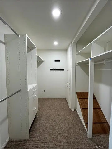 an empty room with a ceiling fan and bathroom view
