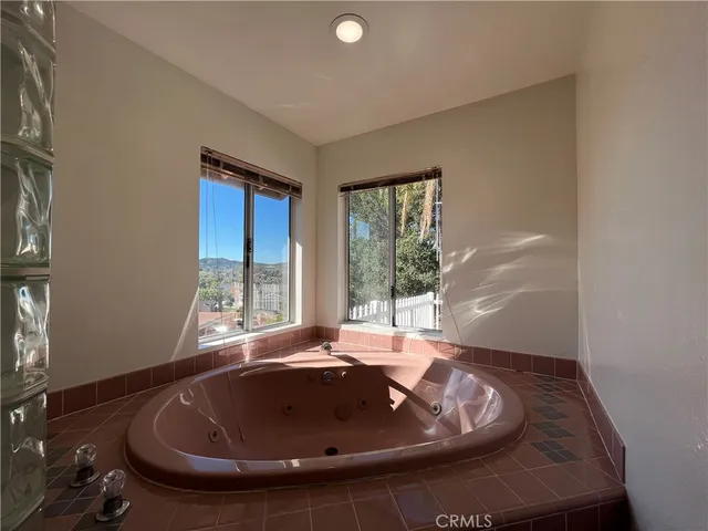a spacious bathroom with a shower a sink and mirror