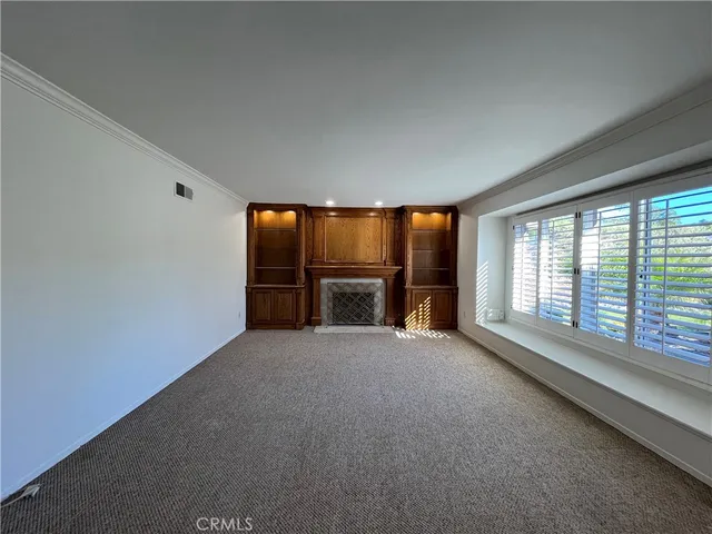 an empty room with large windows and an outdoor view