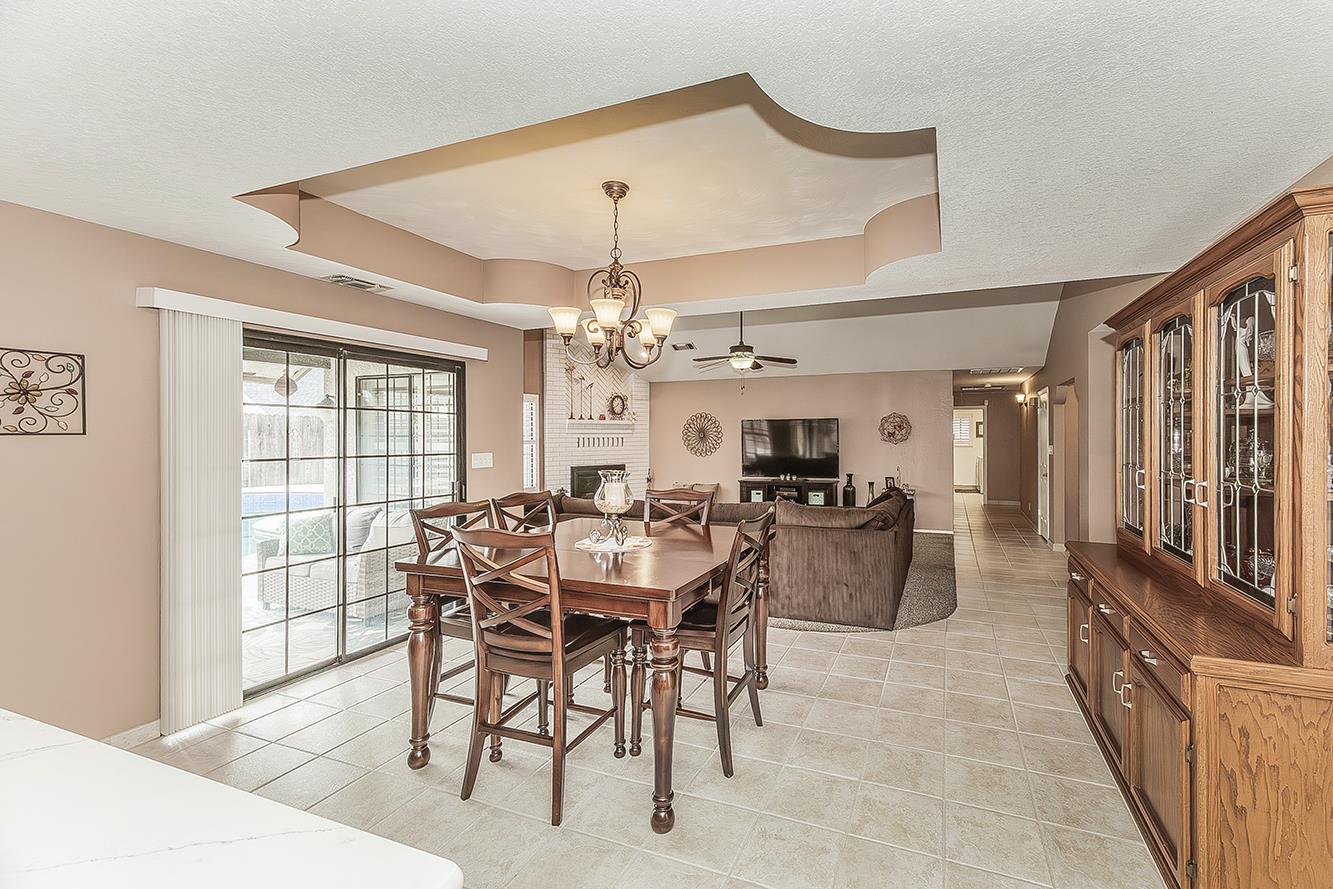 1405 West Flora Avenue Reedley, CA 93654 - Photo 16 of 61 a view of a dining room with furniture window and wooden floor