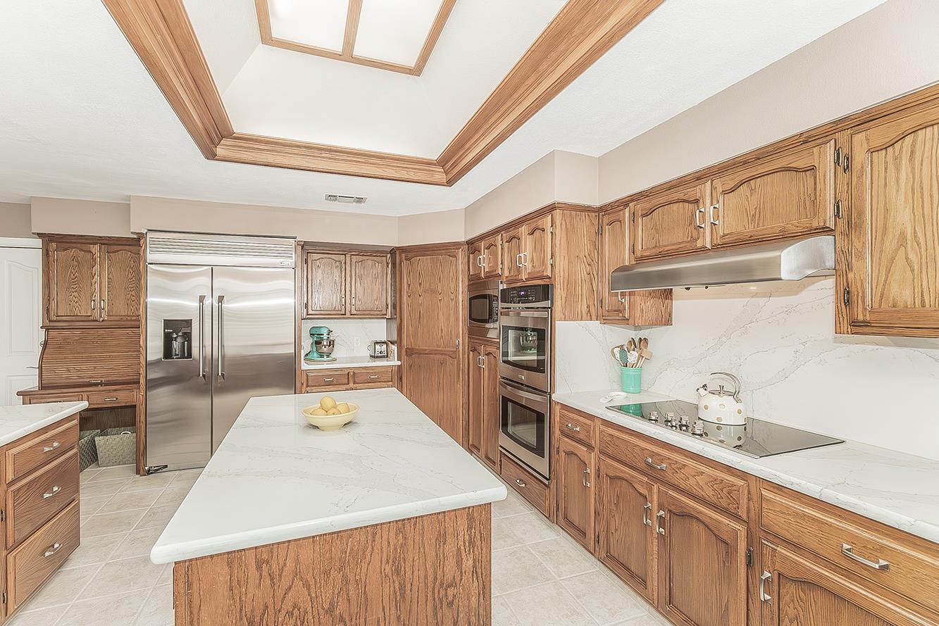 1405 West Flora Avenue Reedley, CA 93654 - Photo 22 of 61 a large kitchen with stainless steel appliances kitchen island granite countertop a refrigerator and a stove top oven