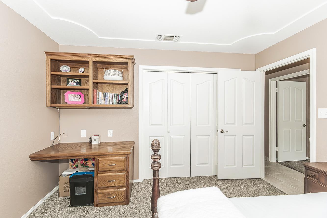 1405 West Flora Avenue Reedley, CA 93654 - Photo 34 of 61 a bedroom with a bed and a table in it