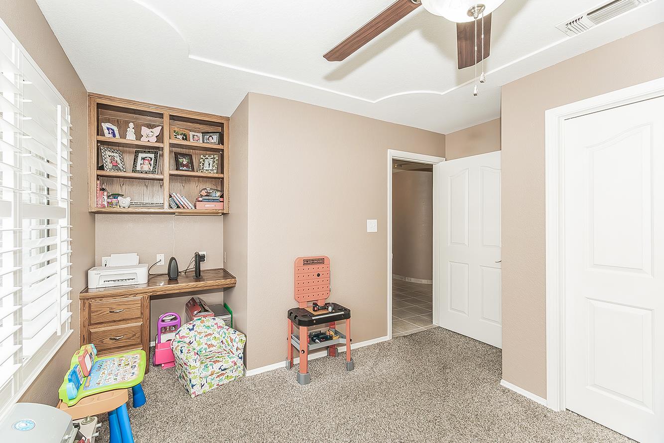 1405 West Flora Avenue Reedley, CA 93654 - Photo 39 of 61 a living room with furniture and book shelf