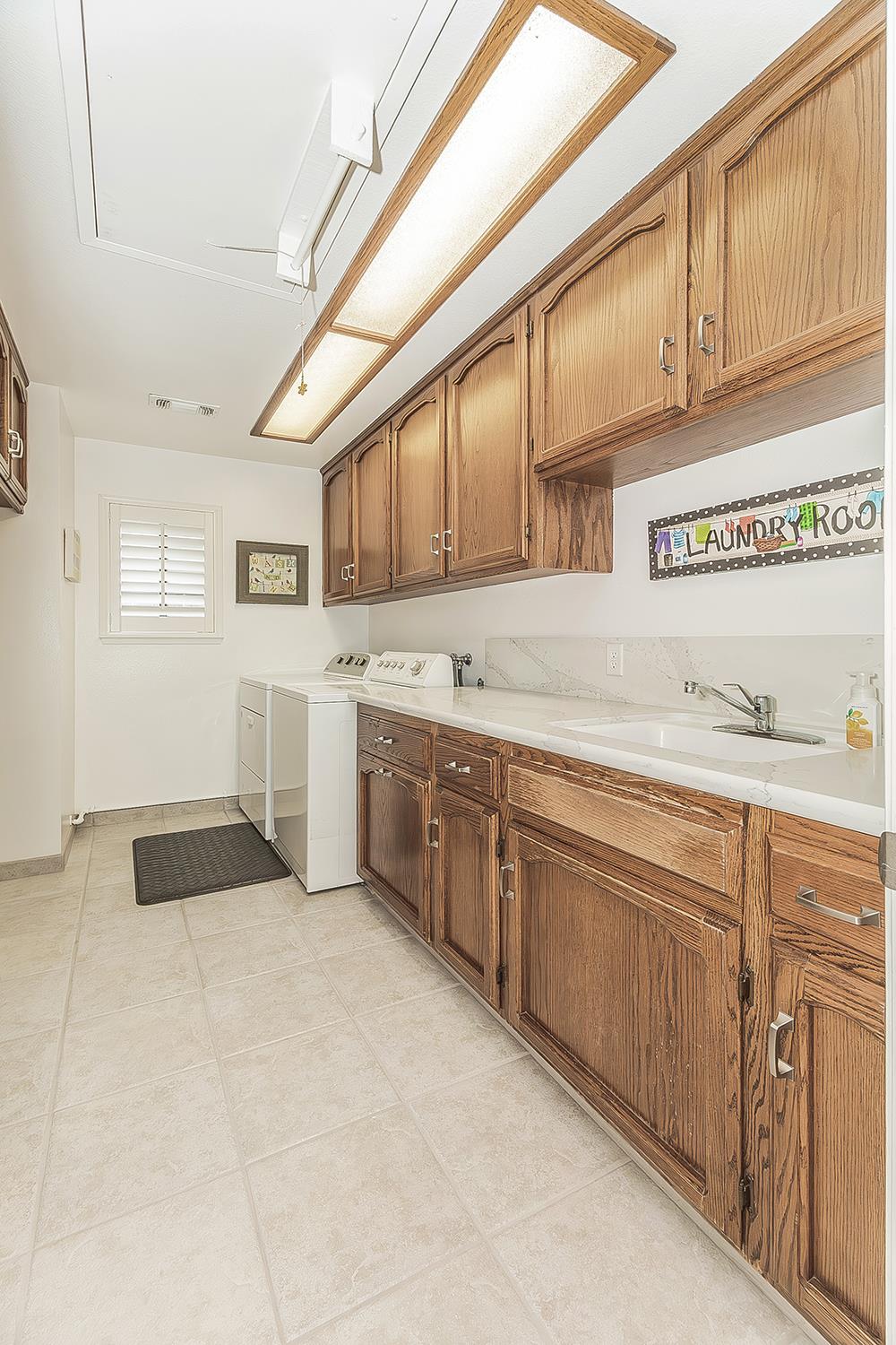 1405 West Flora Avenue Reedley, CA 93654 - Photo 41 of 61 a kitchen with stainless steel appliances granite countertop a sink and cabinets