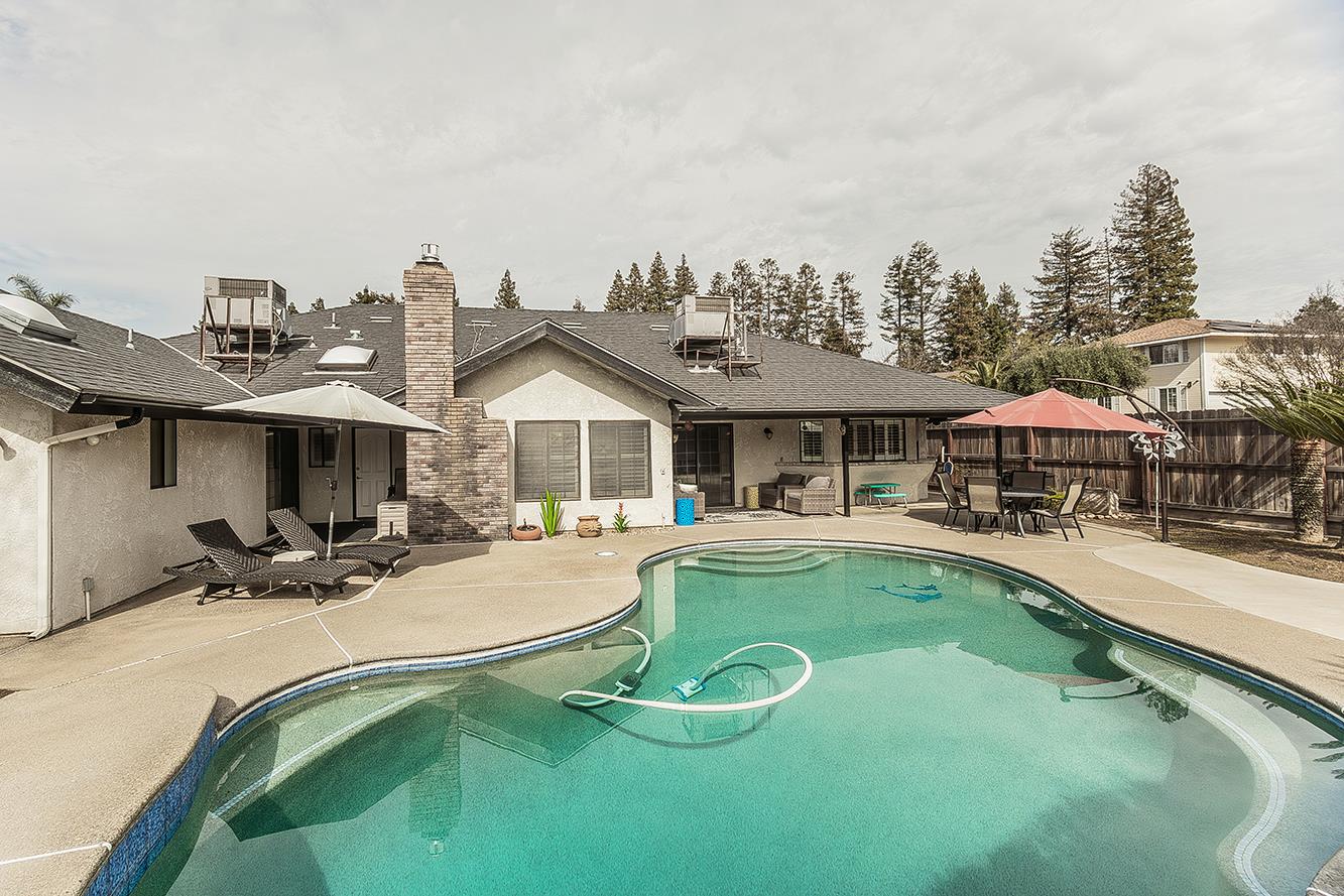 1405 West Flora Avenue Reedley, CA 93654 - Photo 53 of 61 a view of a house with swimming pool and sitting area