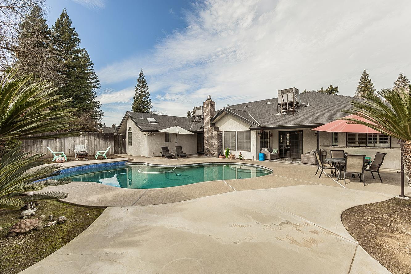 1405 West Flora Avenue Reedley, CA 93654 - Photo 54 of 61 a view of a house with swimming pool and sitting area