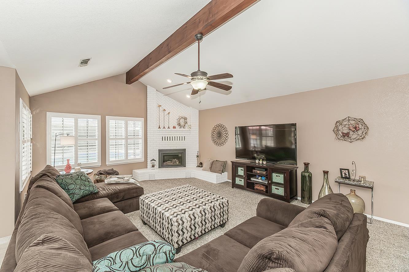 1405 West Flora Avenue Reedley, CA 93654 - Photo 8 of 61 a living room with furniture ceiling fan and a flat screen tv