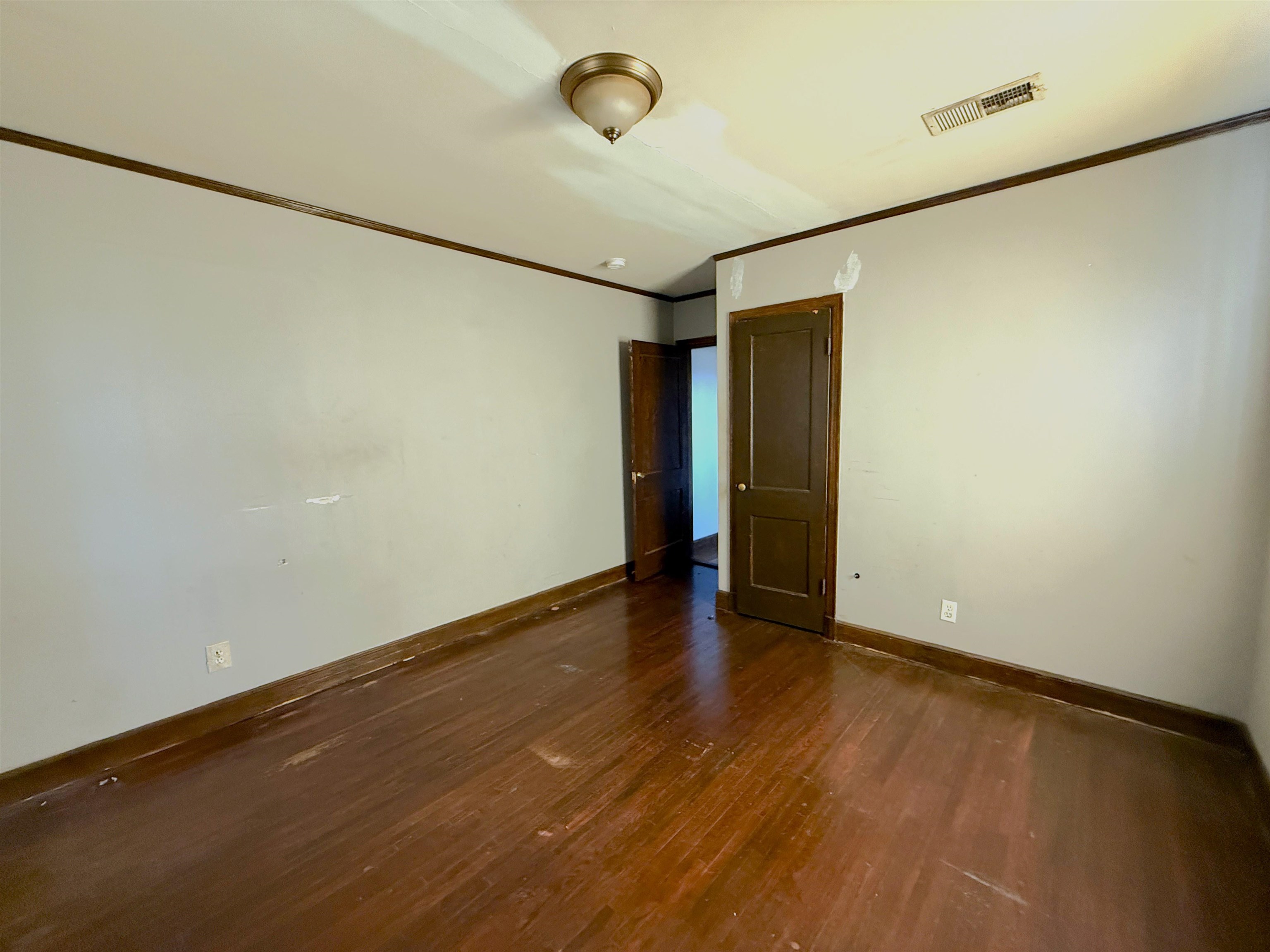 1229 Marlin Road Memphis, TN 38116 - Photo 14 of 20 Spare room with dark wood-style floors and ornamental molding