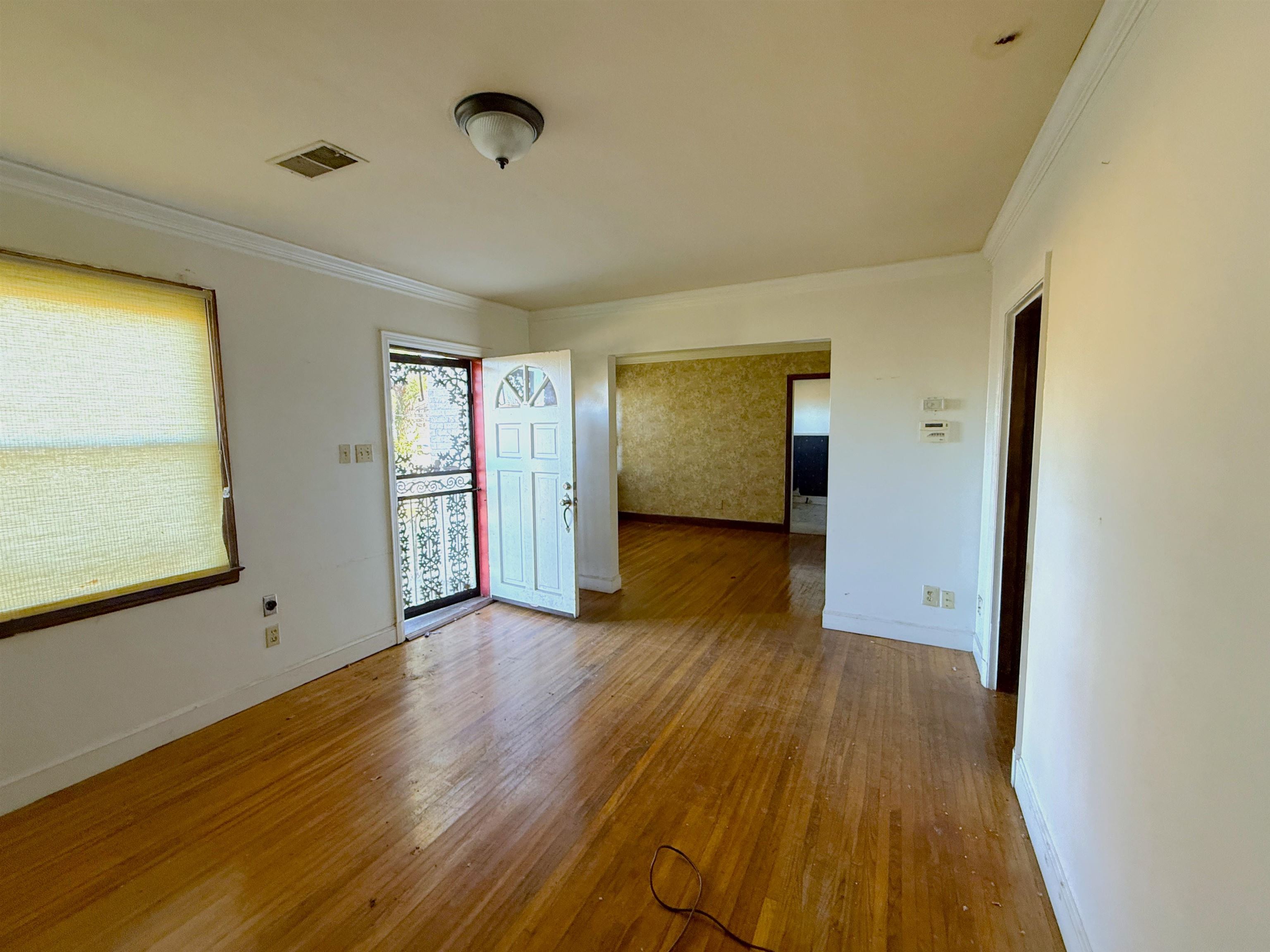1229 Marlin Road Memphis, TN 38116 - Photo 18 of 20 Spare room with hardwood / wood-style floors and ornamental molding