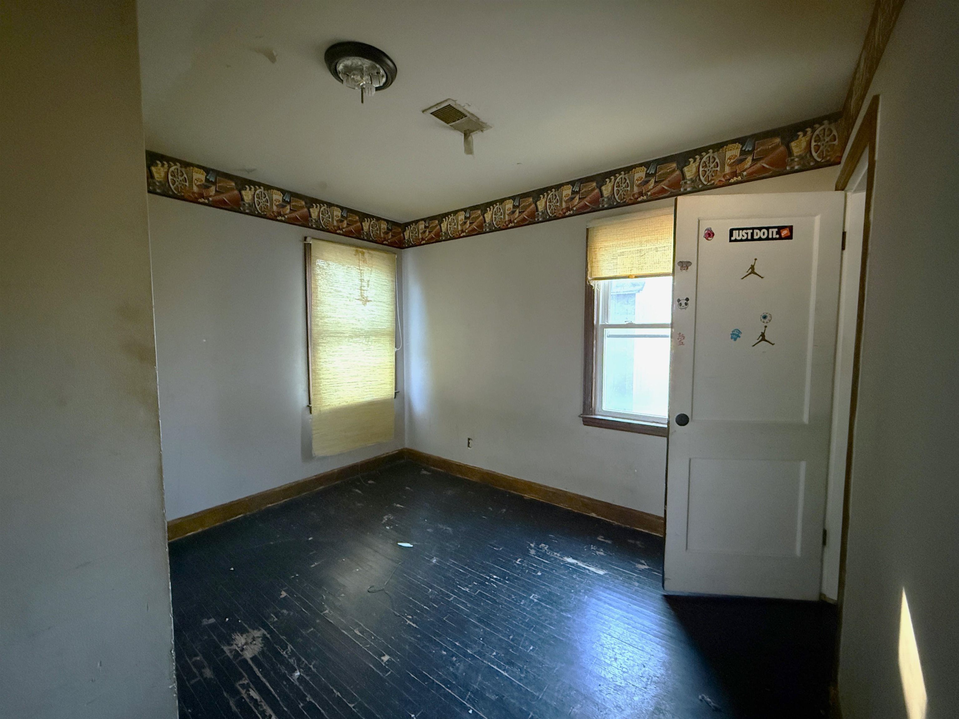 1229 Marlin Road Memphis, TN 38116 - Photo 7 of 20 Unfurnished room featuring dark wood-type flooring and plenty of natural light