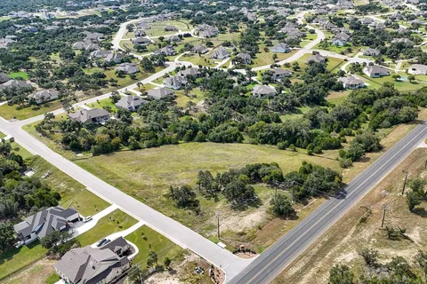 a view of a yard with wooden fence