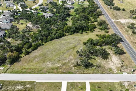 a view of a yard with wooden fence