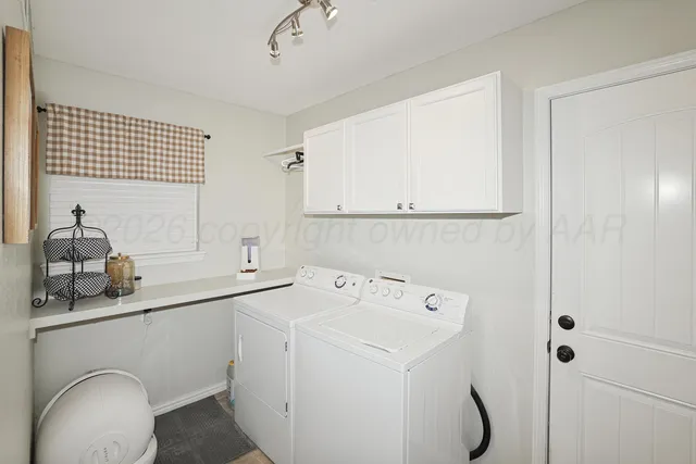a kitchen with cabinets and window