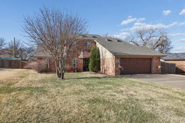 a view of a house with a yard and garage