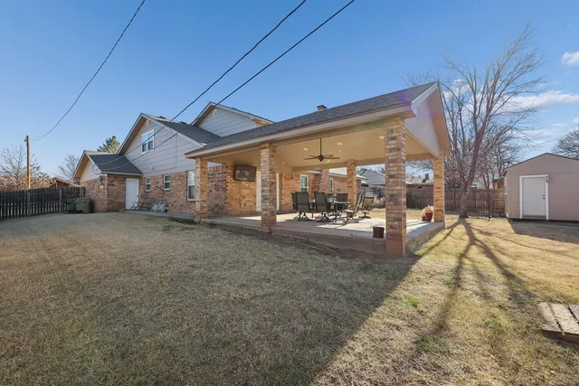 a view of a house with a yard covered in snow