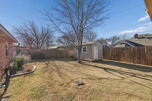 a view of a backyard with a large tree